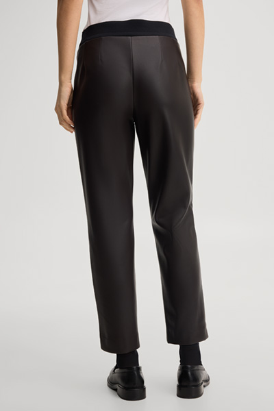 Leads to product detail page "Faux leather cigarette trousers in dark brown"