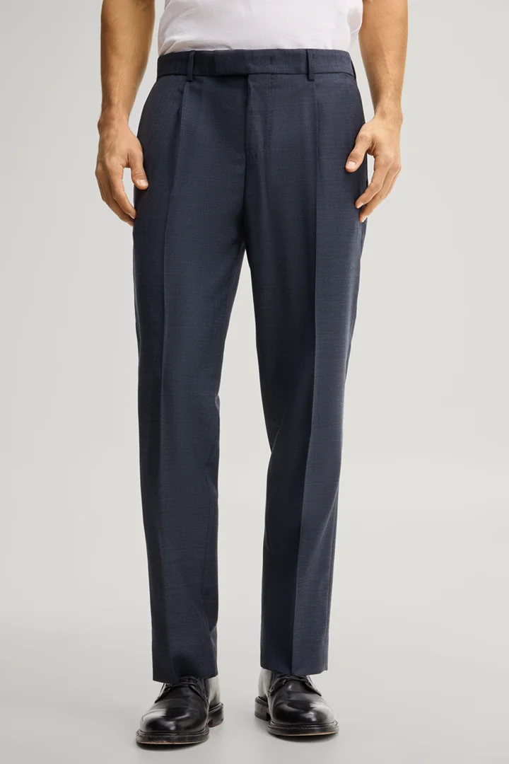 Leads to product detail page "Modular trousers in navy, made from virgin wool"