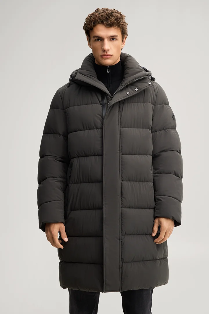 Leads to product detail page "Quilted coat in dark green"