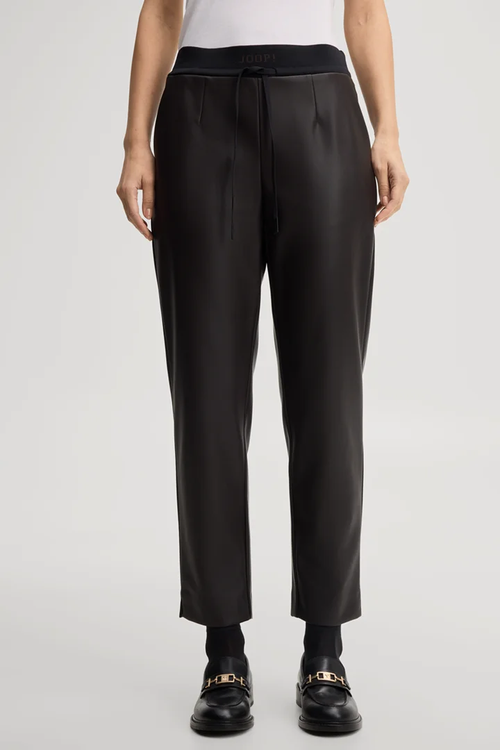 Leads to product detail page "Faux leather cigarette trousers in dark brown"