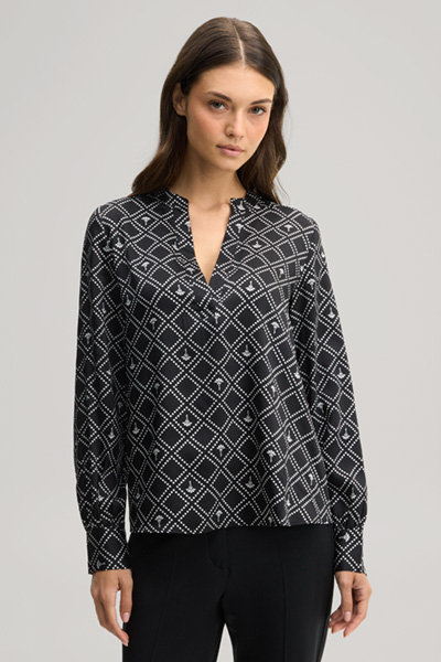 Leads to product detail page "Cornflower blouse in black and ecru pattern"