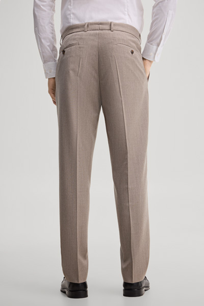 Leads to product detail page "Modular trousers made from virgin wool in light beige"