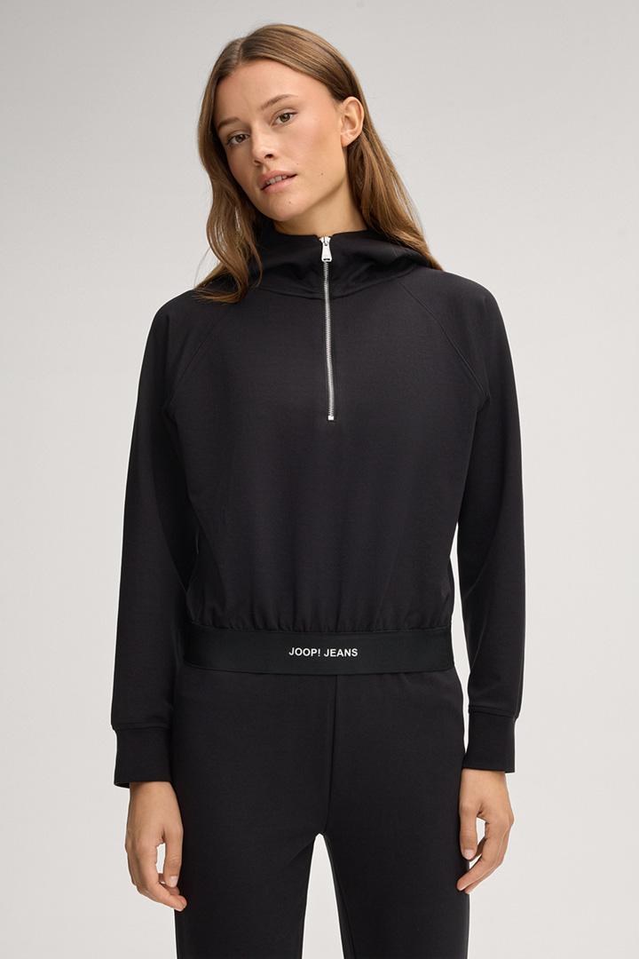 Leads to product detail page "Tulsi Hoodie in Black"