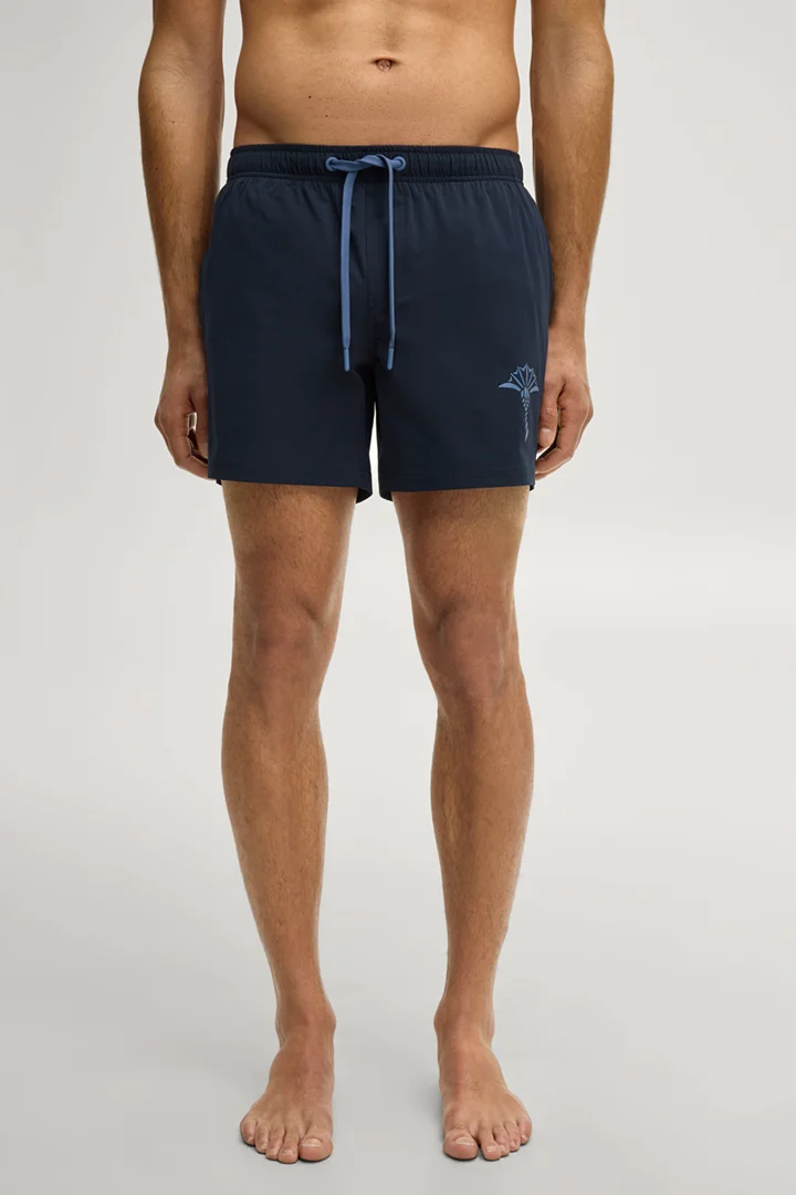 Leads to product detail page "Dark blue swim shorts"