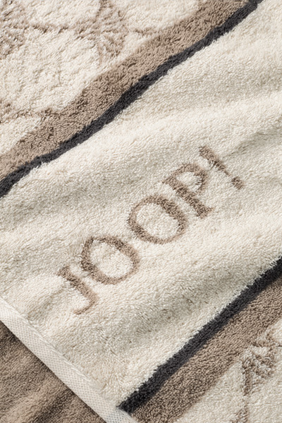 Leads to product detail page "Joop! sauna shower towel in cream and light brown with a pattern"