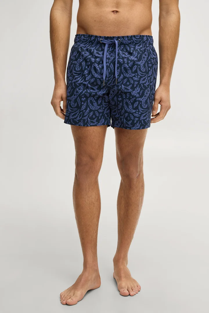 Leads to product detail page "Swim shorts in navy/blue patterned"