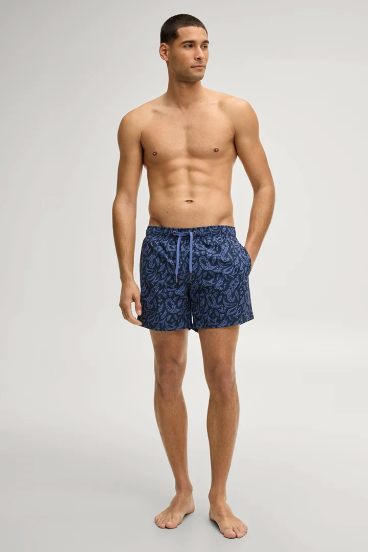 Leads to product detail page "Swim shorts in navy/blue patterned"