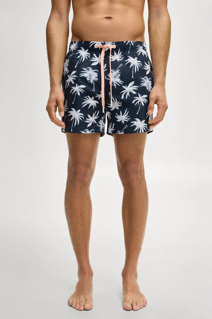 Leads to product detail page "Navy patterned swim shorts"