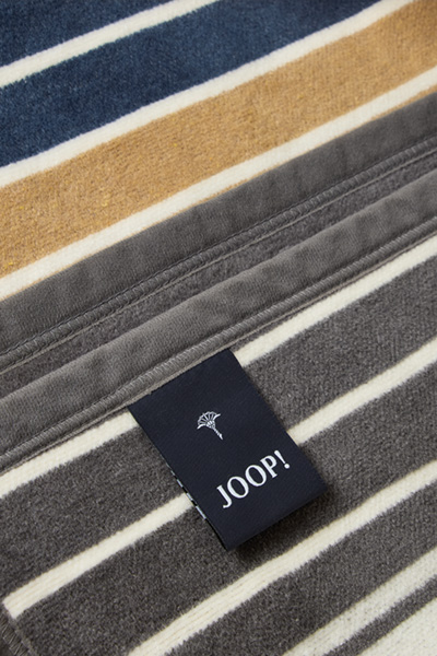 Führt zu Produktdetailseite „Wohndecke JOOP! OUTDOOR LIFESTYLE in Curry/Stein, 125 x 170 cm"